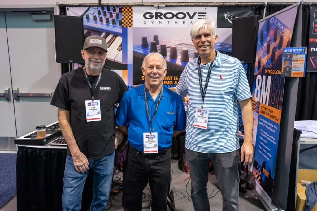 Dan Parks, Dave Rossum, and Bob Coover facing the camera at the Groove Synthesis booth at NAMM 2026
